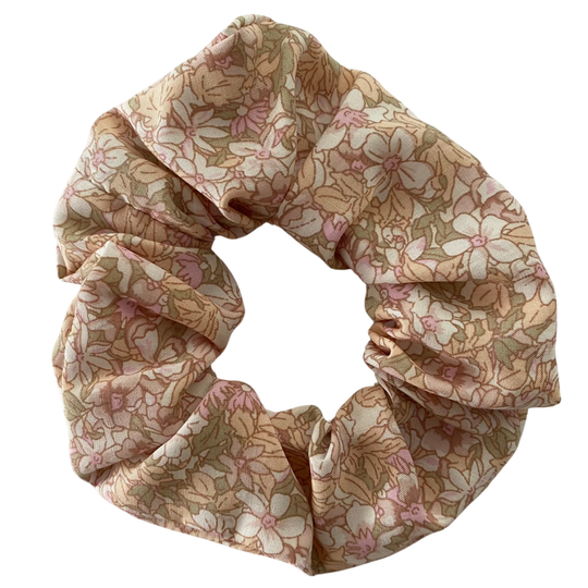 Light pink floral scrunchie made from 100% viscose fabric with a dainty white and baby pink flower print.