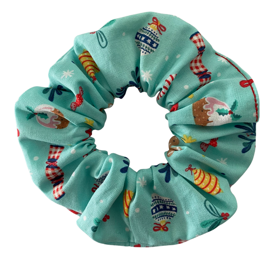 Light blue scrunchie with colourful Christmas images on a white background.