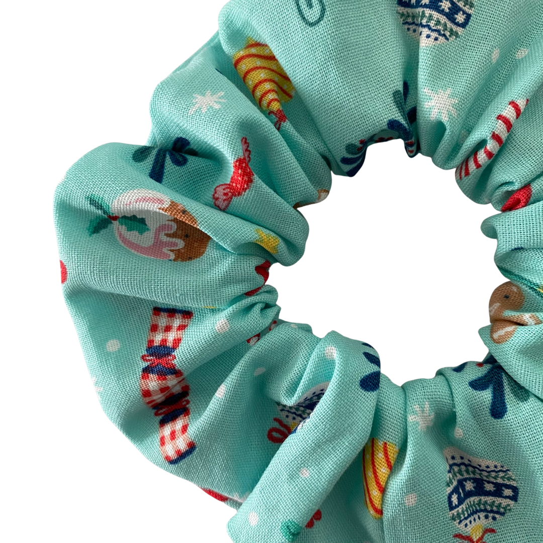 Christmas images featured on a light blue scrunchie.