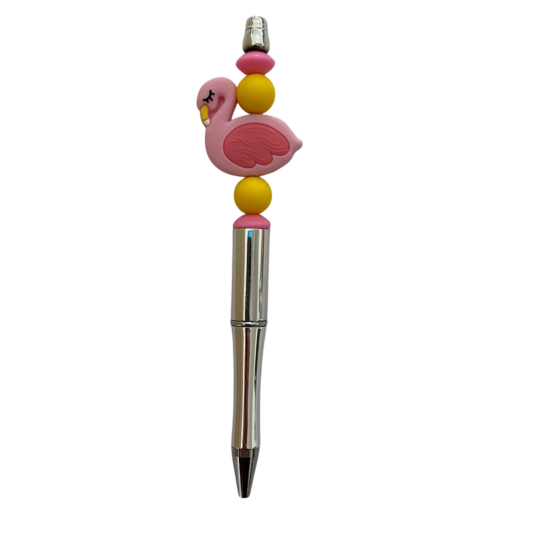 Pen with a flamingo silicone bead on top on a white background.