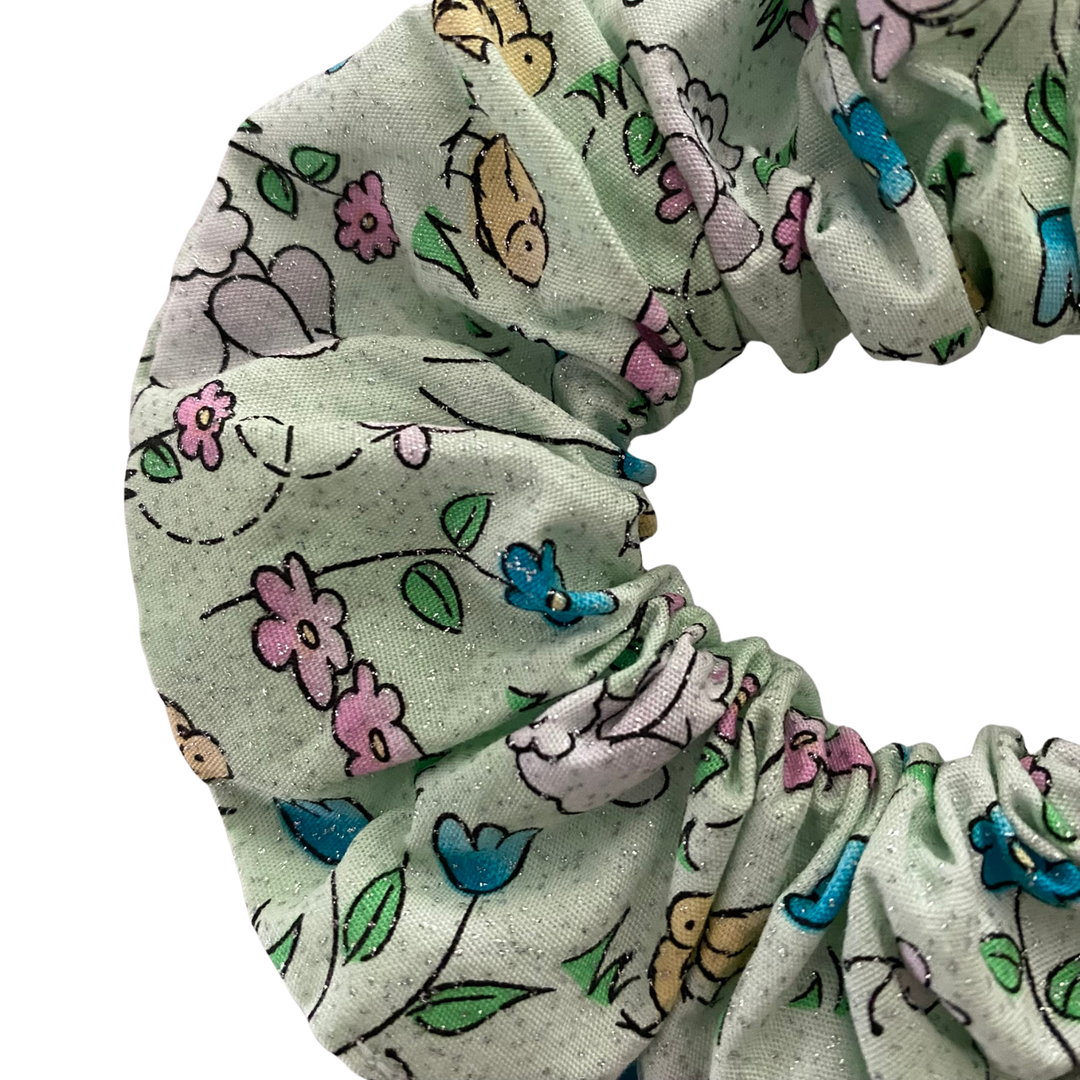 Floral and animal patterned scrunchie on a white background.