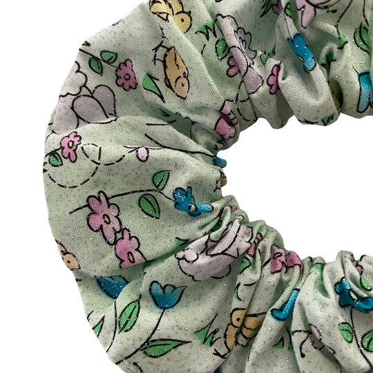 Floral and animal patterned scrunchie on a white background.