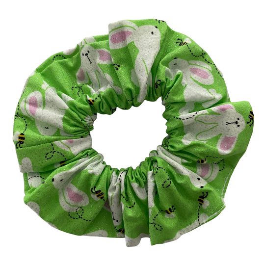 Green scrunchie with white rabbit pattern on a white background.