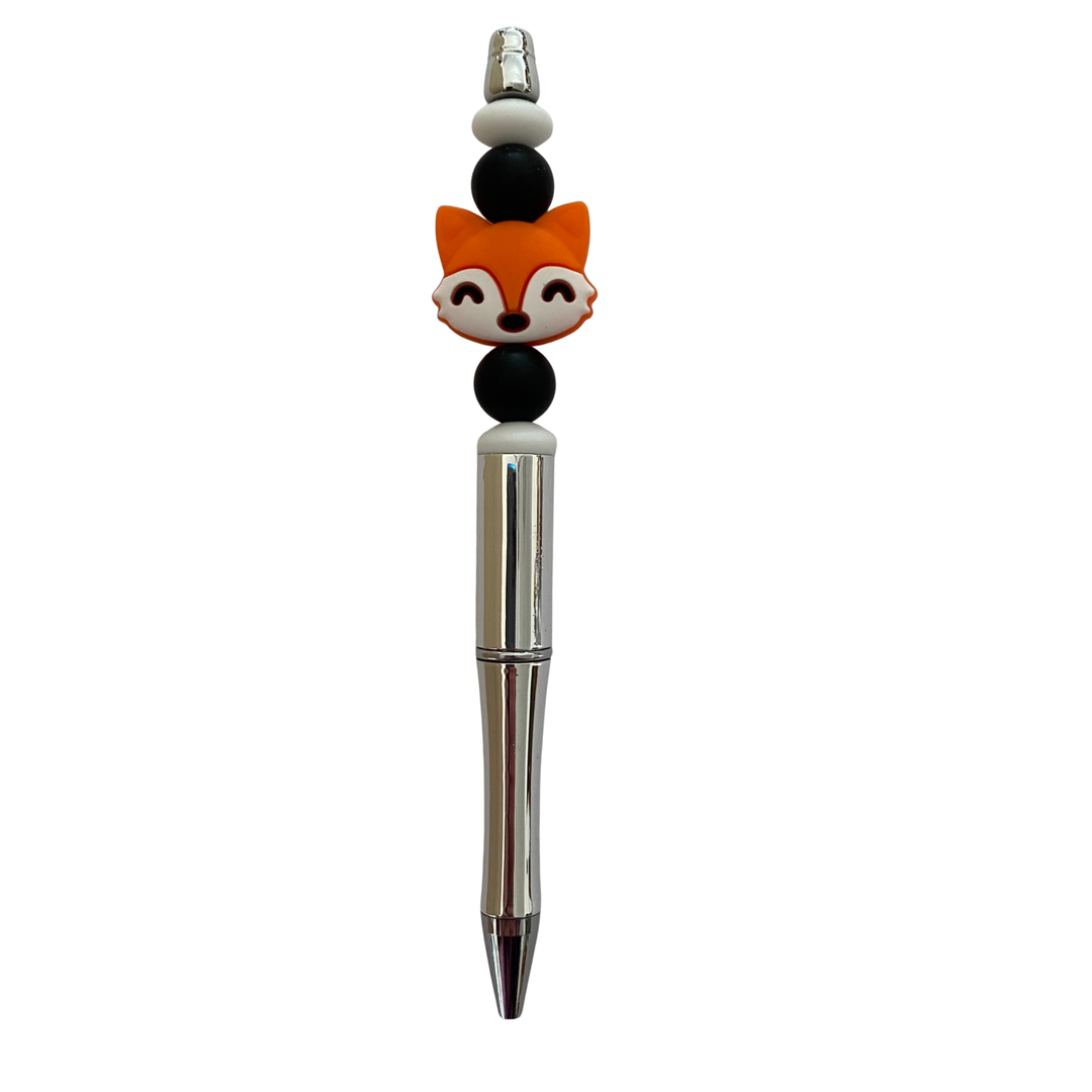 Pen with a fox silicone bead on top on a white background.