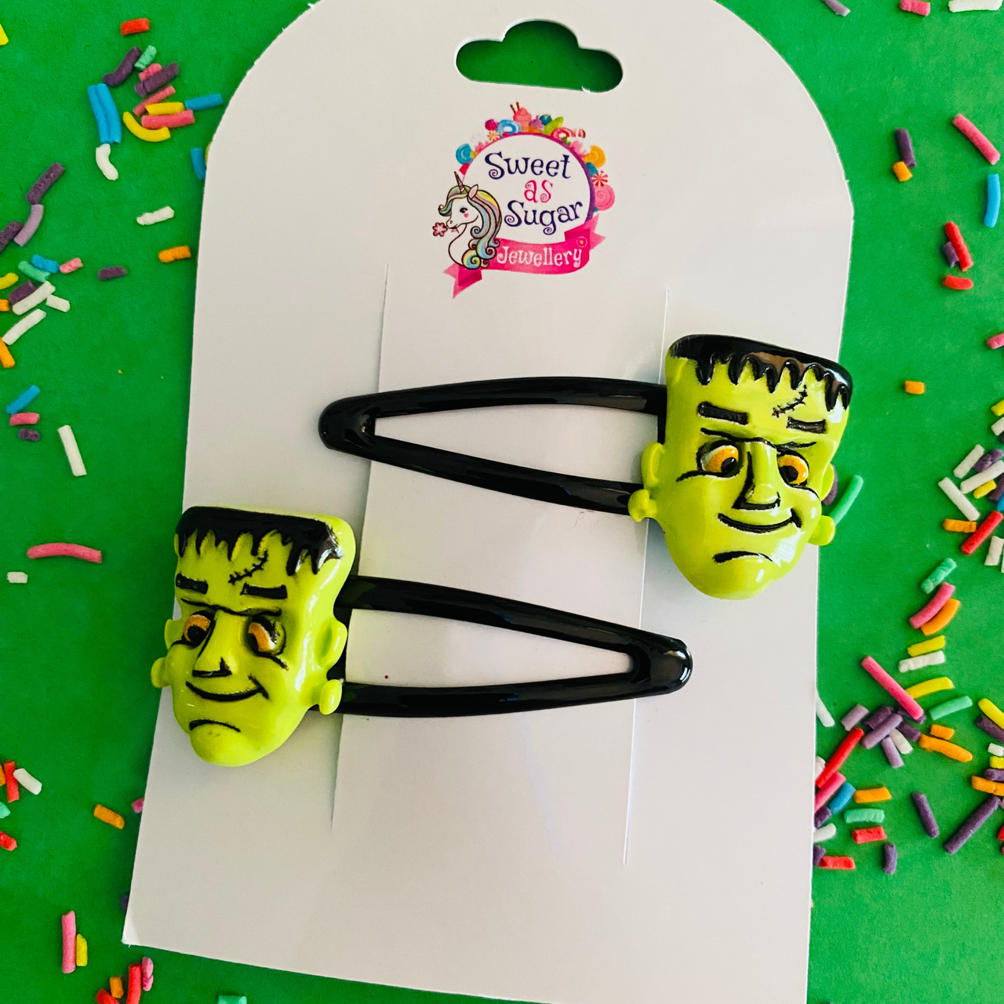 Frankenstein hair clips feature a classic green monster face set on black hair clips.