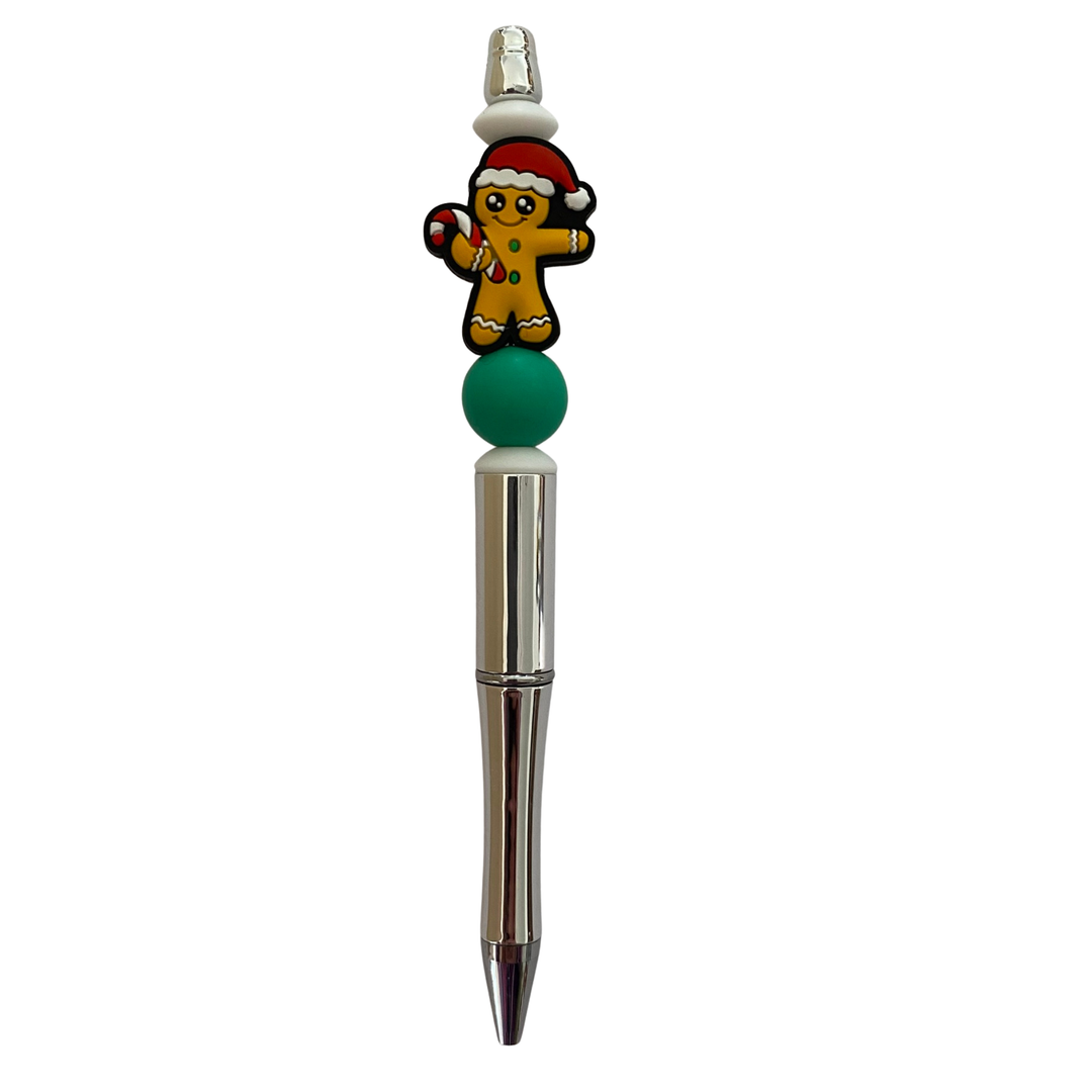 Decorative pen with a gingerbread man design on a white background.