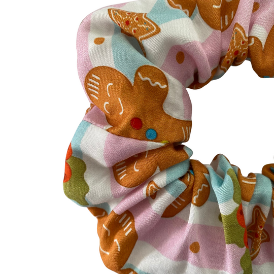 Fabric with gingerbread man pattern on a white background.