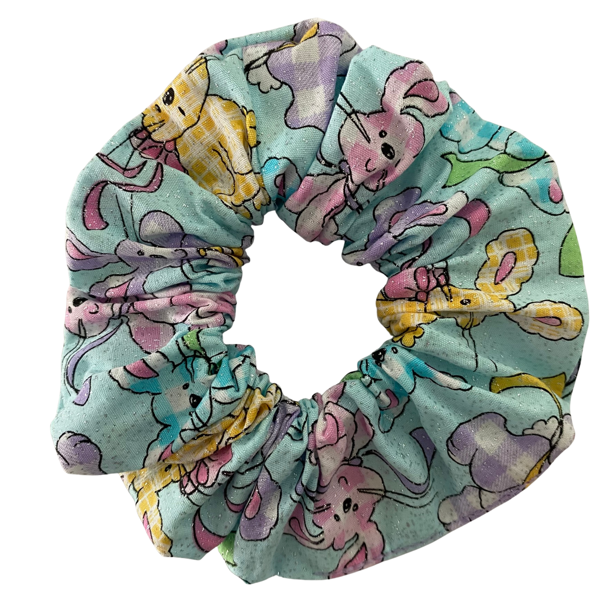 A scrunchie featuring pastel gingham bunnies and glitter on a blue background.