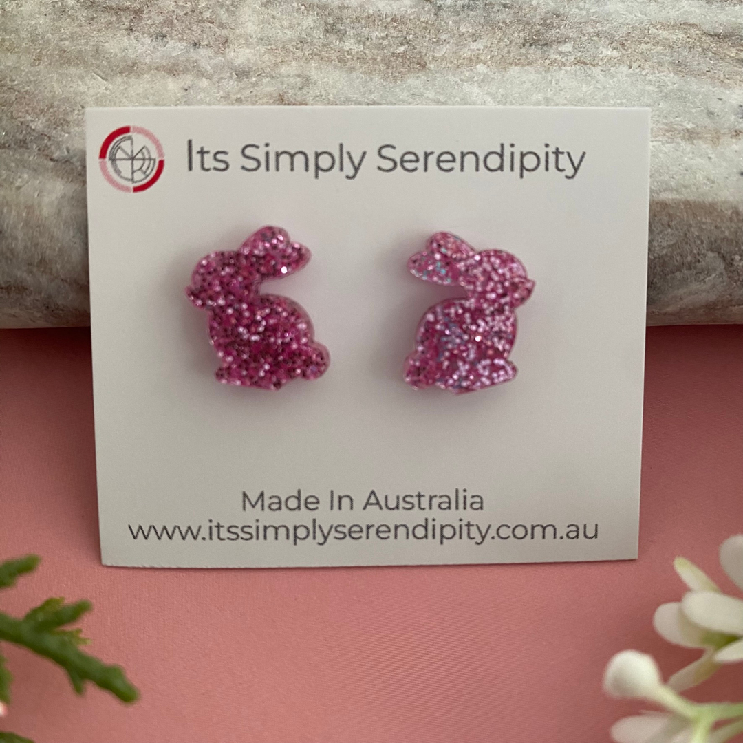 Pink glitter bunny-shaped earrings.