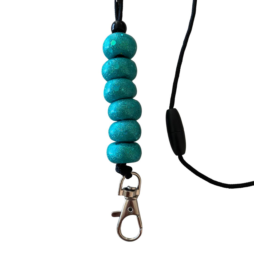 Handmade polymer clay lanyard with six hand-rolled sparkly turquoise beads. Threaded on a nylon cord with a breakaway safety clasp and a silver-plated clip.