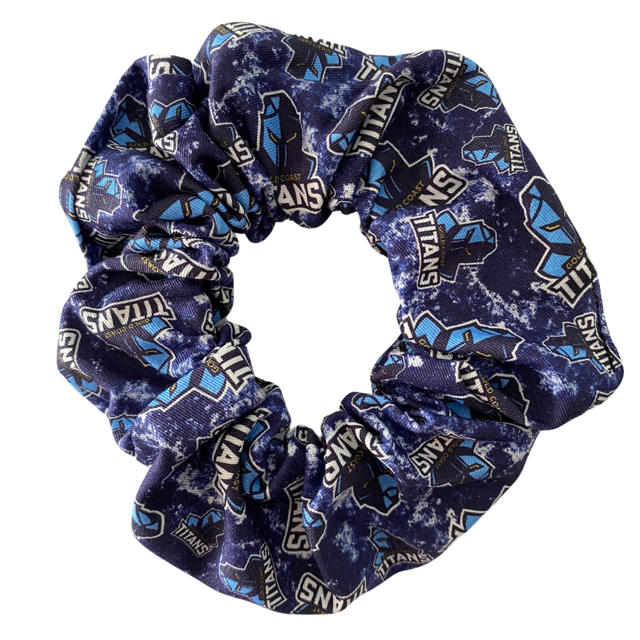 A scrunchie hair tie handmade with cotton woven fabric with images of the Gold Coast Titans rugby league team.