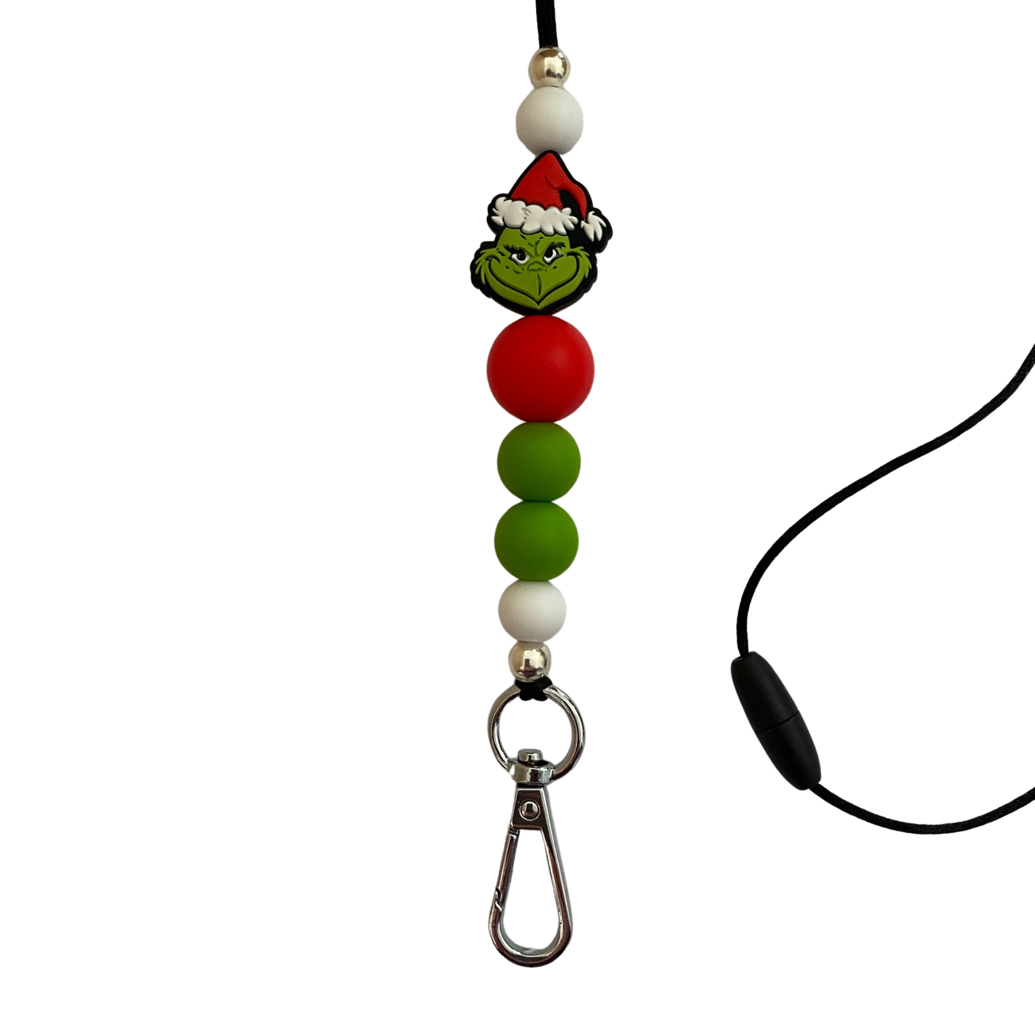A 60cm lanyard fitted with a safety break away clasp and a Grinch silicone bead and other coloured round silicone beads.