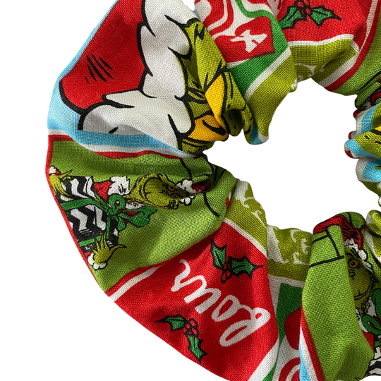 The grinch featured on a red and green scrunchie.