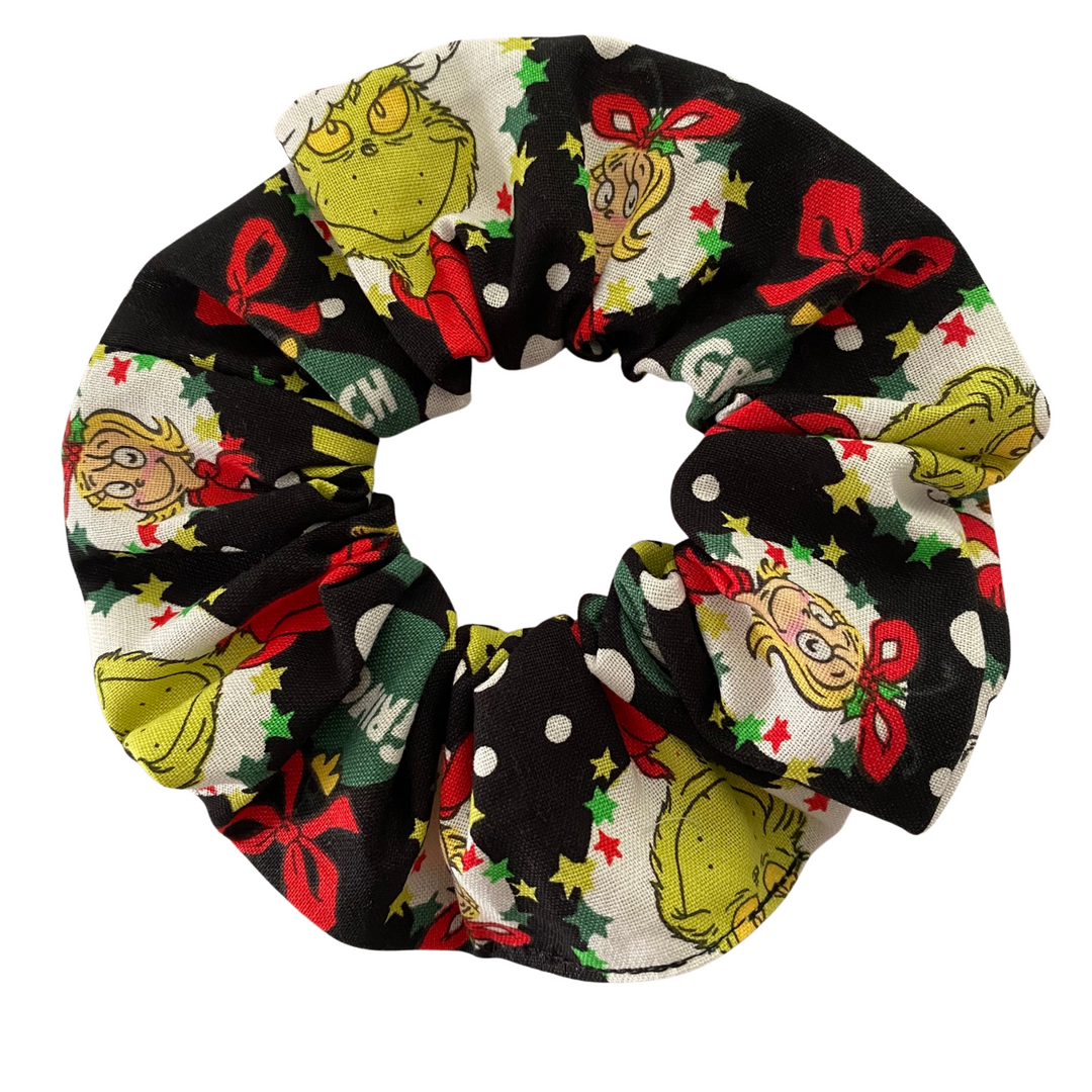 Scrunchie with festive Grinch design on a white background.