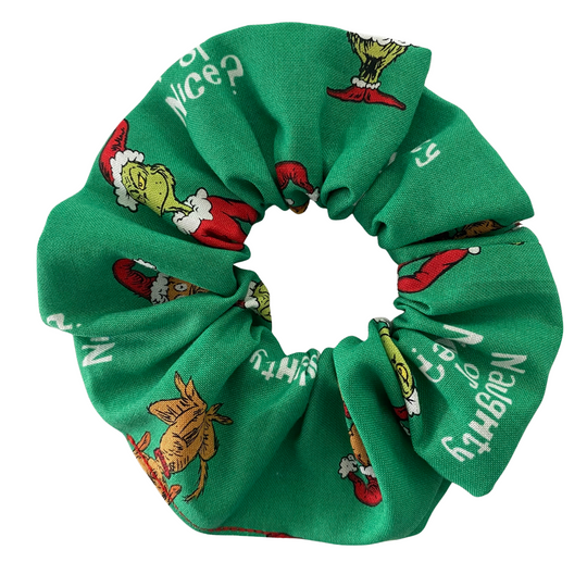 Green scrunchie with Grinch character print on a white background.