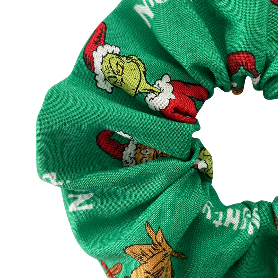 Grinch character images on a green scrunchie.