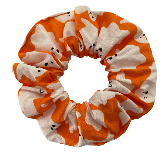 Halloween Scrunchie featuring white ghosts on orange soft cotton woven fabric.