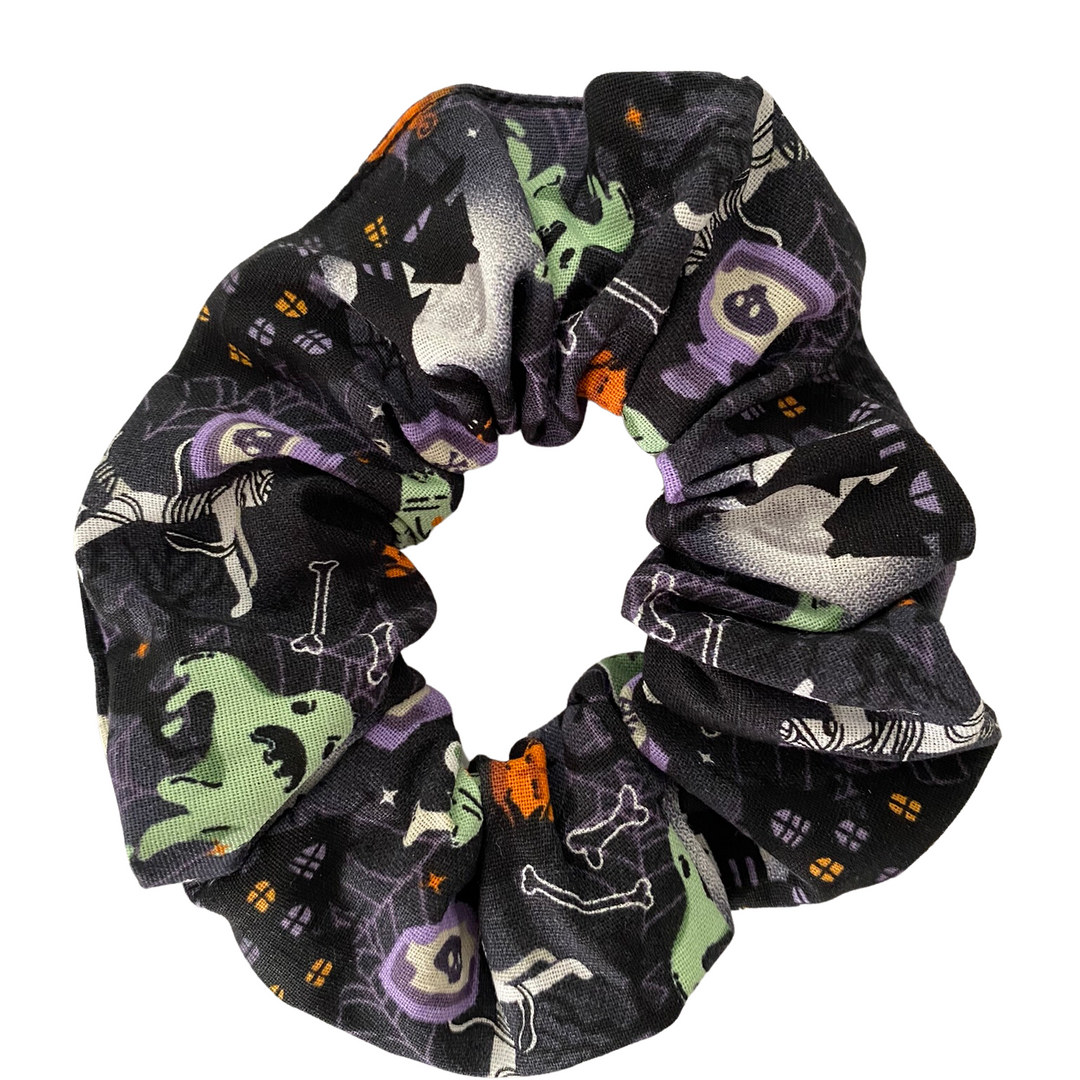 Halloween Scrunchie featuring mummies, bones, potions, haunted houses on black soft cotton woven fabric.