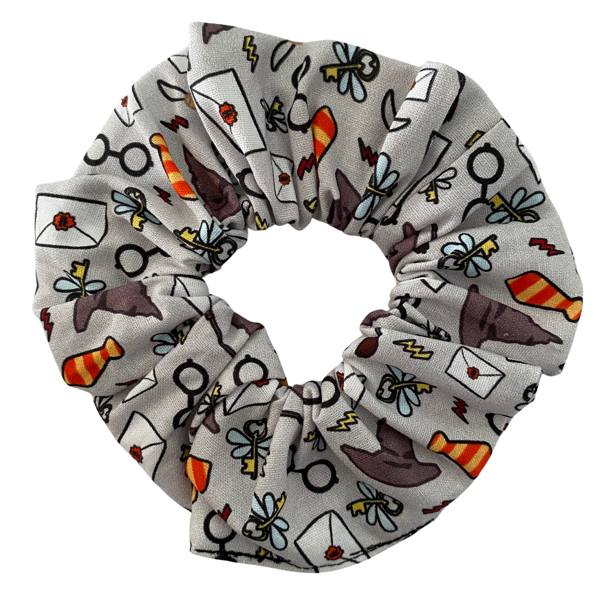 This enchanting scrunchie features iconic imagery from the wizarding world—including the Sorting Hat, Golden Snitch, winged keys, and more. 