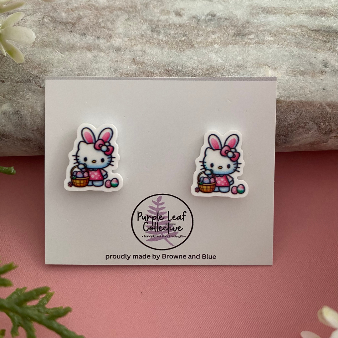 Easter standing Hello Kitty wearing a pink bow holding a colourful Easter Egg basket stud earrings.