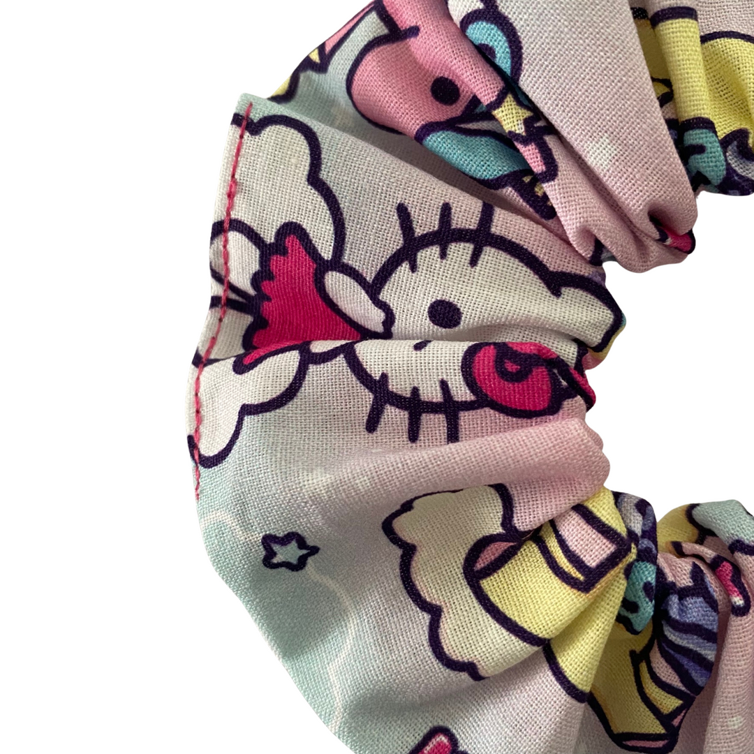 Close up view of Hello Kitty themed scrunchie on a white background.
