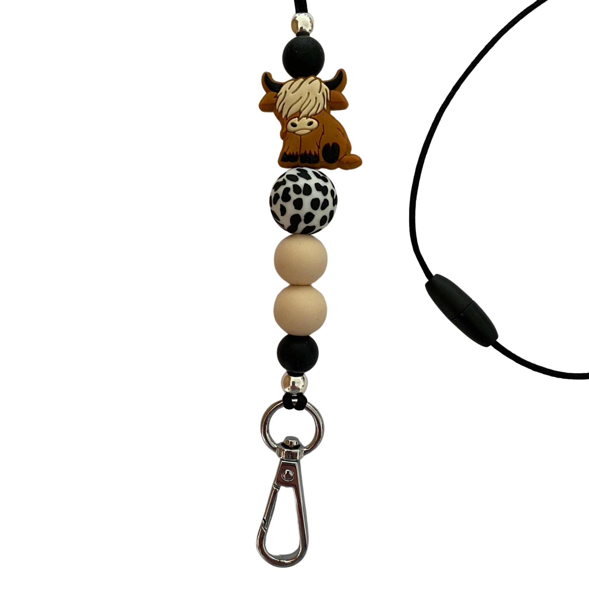 A 60cm black cord lanyard with breakaway clasp with a Tan Highland Cow silicone bead and other coloured silicone beads.