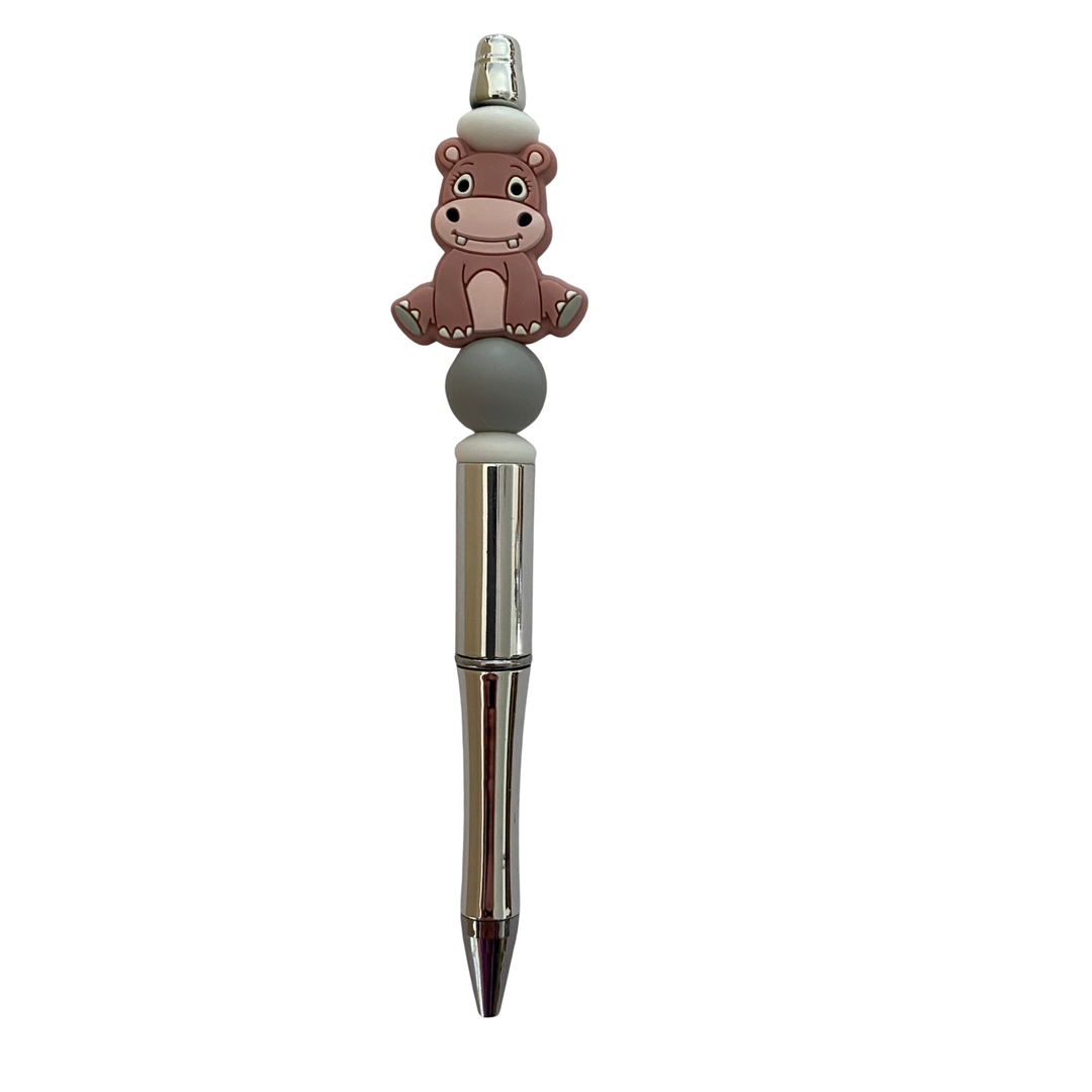 Pen with a Hippopotamus silicone bead on top on a white background.