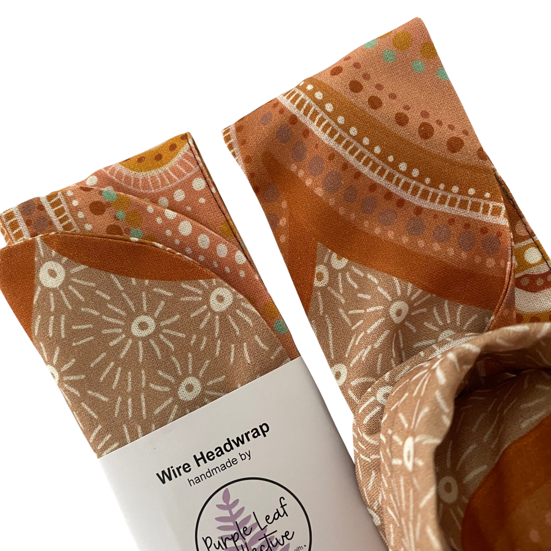 Close up view of Sacred Country Wire Headwrap by Holly Sanders. Handmade cotton headwrap featuring contemporary Aboriginal art representing spiritual connection to Country and sacred sites.