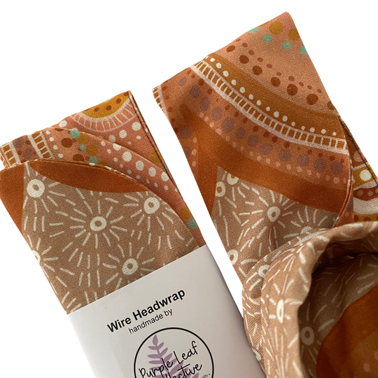 Close up view of Sacred Country Wire Headwrap by Holly Sanders. Handmade cotton headwrap featuring contemporary Aboriginal art representing spiritual connection to Country and sacred sites.