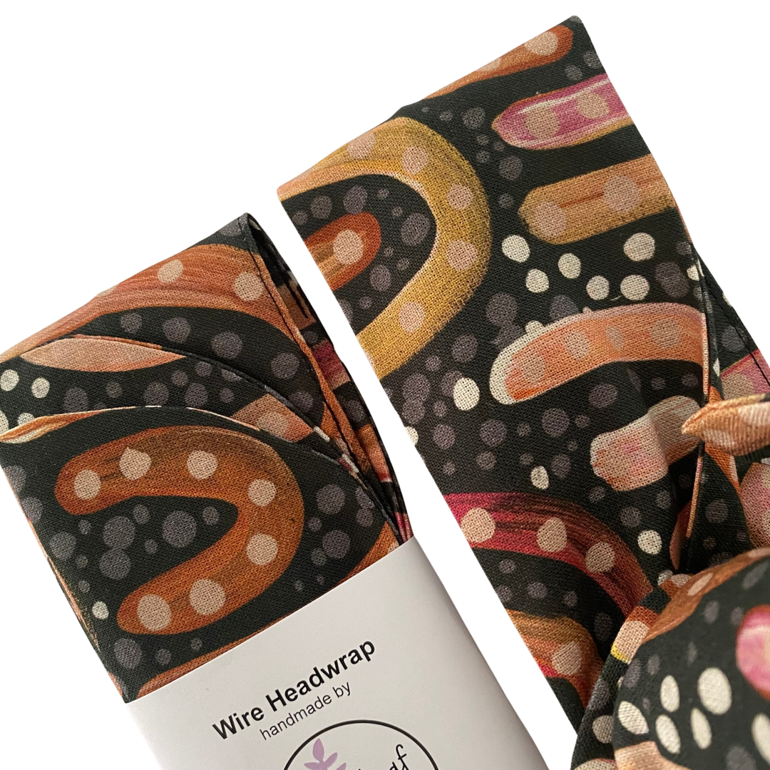 Close up view of patterns of our Aboriginal art wire headwrap by Holly Sanders, depicting sacred sandhill landscapes on woven cotton fabric.