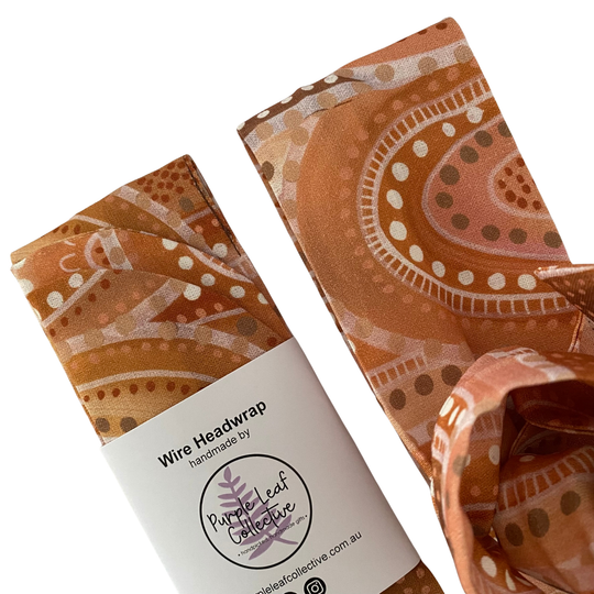 Close up view of our handmade cotton wire headwrap featuring Sandhills Aboriginal artwork by Holly Sanders. This stunning design captures the warm, golden hues of the sun setting over the sandhills.
