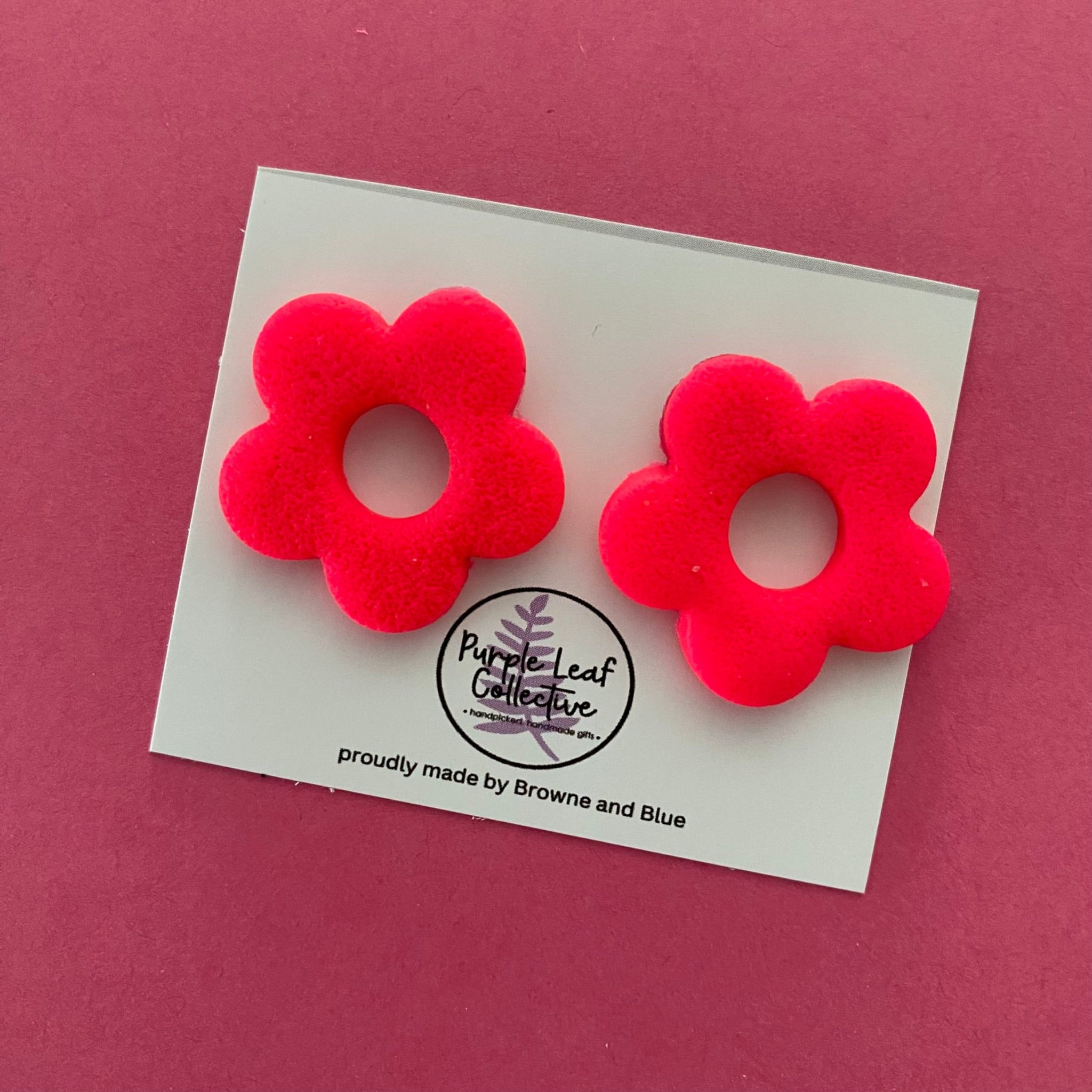 Drop stud earrings with five hot pink polymer clay flower petals, set on surgical steel posts for comfort and durability.