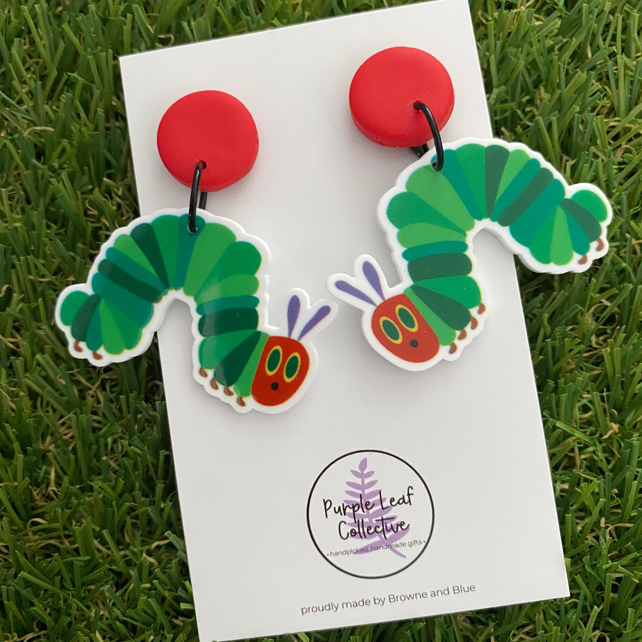 Pair of hungry caterpillar dangle earrings with a red stud topper.