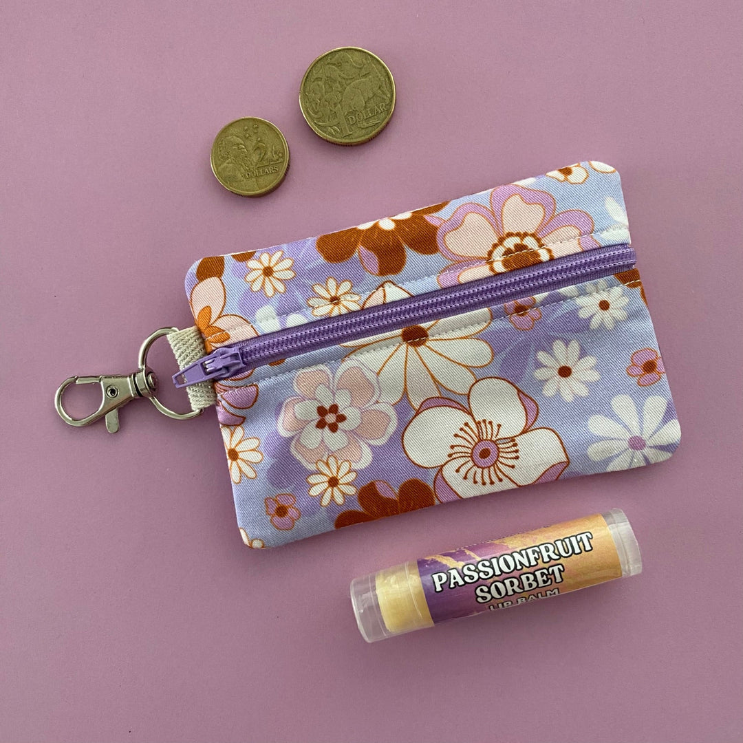 A small clip coin purse perfect for coins and small essentials featuring fabric in retro blooms and lilac periwinkle colour by Jac Slade. 