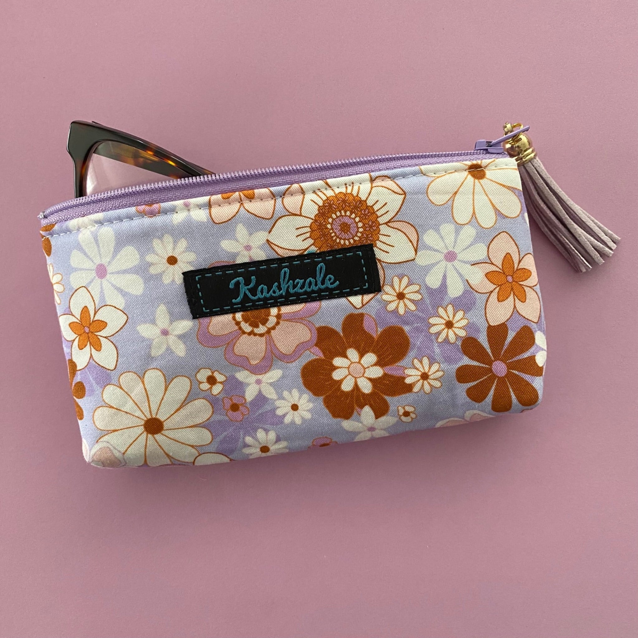 Protect your glasses with our padded, fully lined glasses case featuring colourful retro flowers on lilic fabric by Jac Slade. Perfect pouch for eyewear and small essentials.