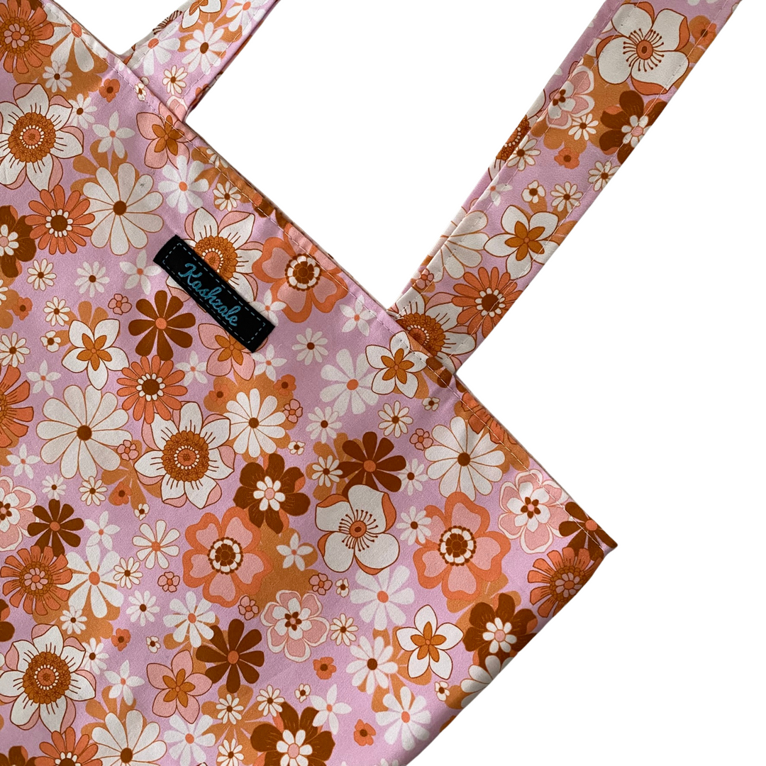 A close up view of the Retro Blooms Pink Blush reversible tote bag, handmade with Jac Slade fabric. Washable, eco-friendly, and perfect for everyday use.