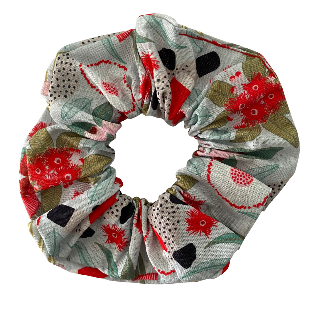 Aussie native animals and florals patterned scrunchie on a white background.
