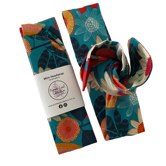Handmade wire headwrap, headband with banksia and native flowers set on teal colour fabric by Jocelyn Proust. Stylish, adjustable, and perfect for all-day wear or hair loss coverage.