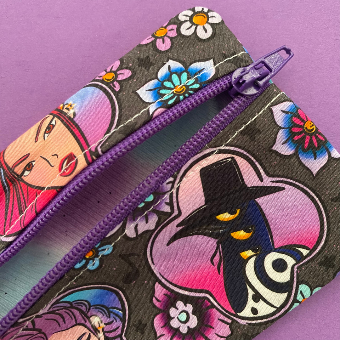 Lining view of the mini pouch coin purse featuring images of K-Pop Demon Hunters on black fabric.