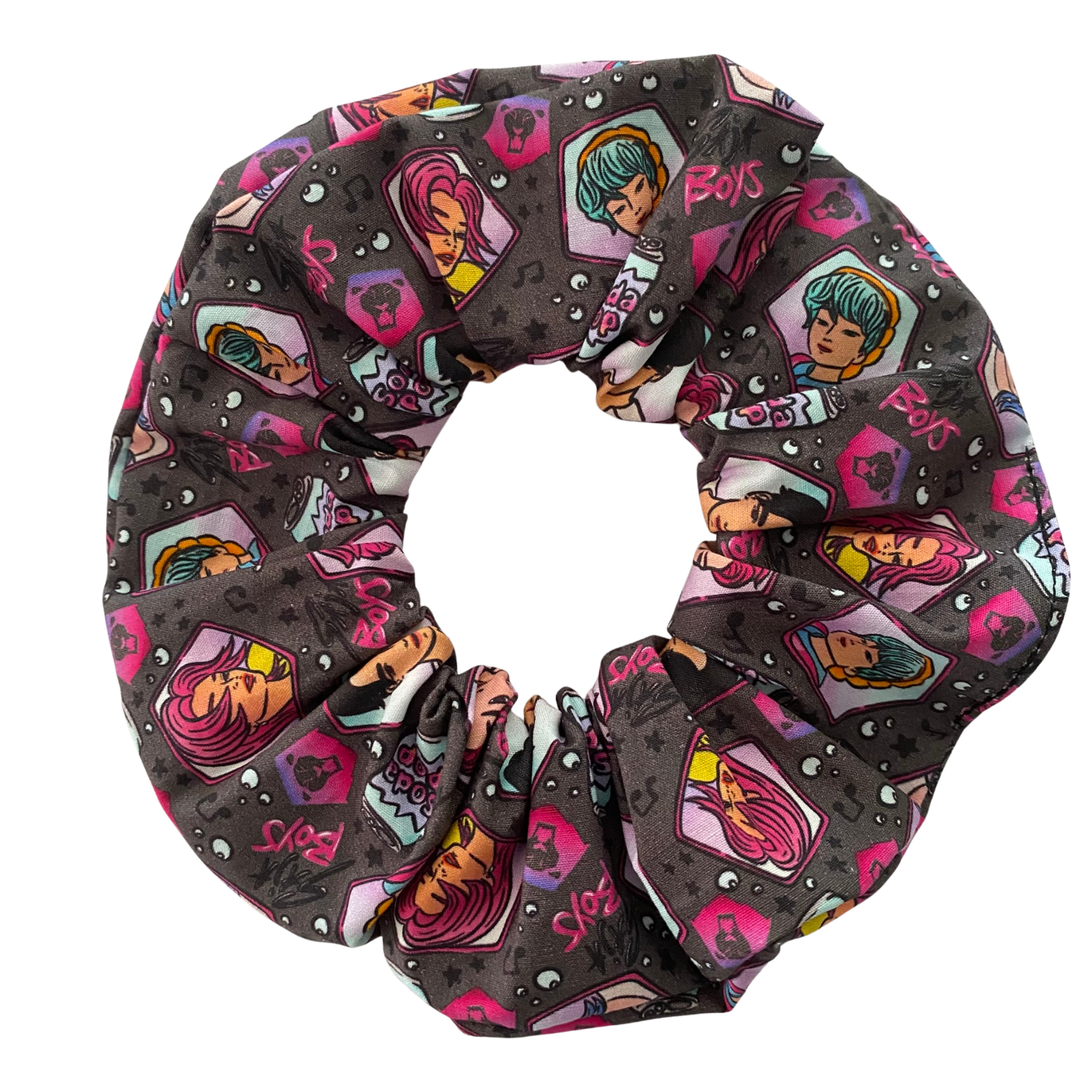 K-Pop Demon Hunters Saja Boys Scrunchie is handmade from cotton poplin fabric featuring images of Jinu, Abby, Mystery, Romance and Baby along with cans of Soda Pop.