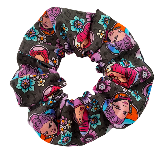 A scrunchie featuring characters from K-Pop Demon Hunters on a black fabric.