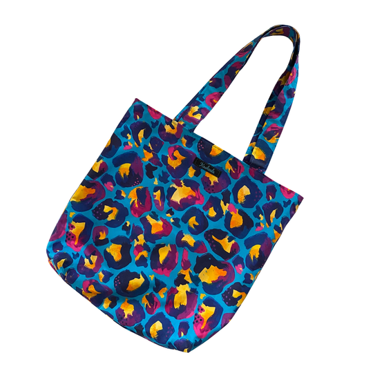 Tote bag with colourful blue leopard print pattern on a white background.