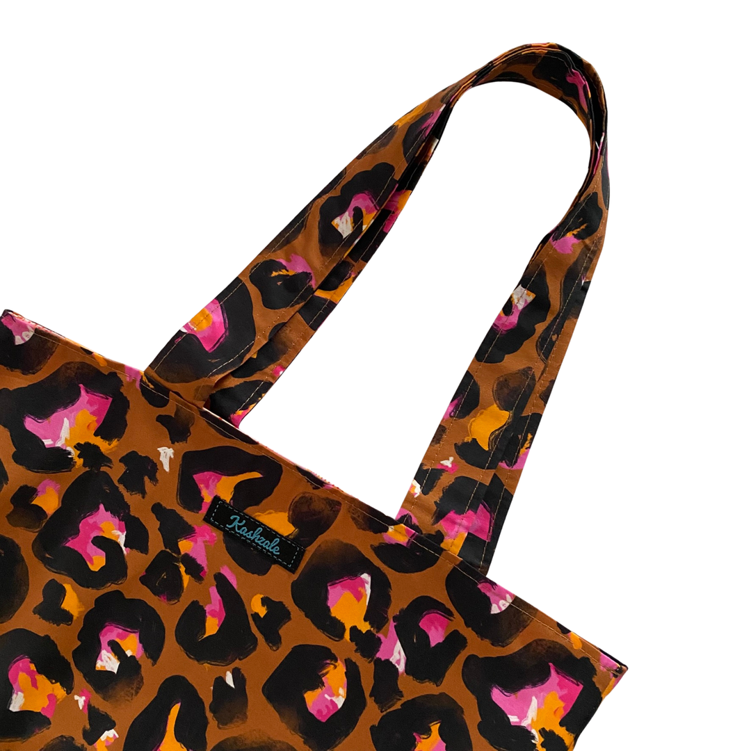Bronze Leopard print tote bag with a visible brand logo on a white background.