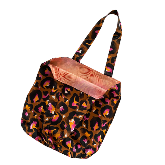 Bronze Leopard print tote bag with a pink interior on a white background.