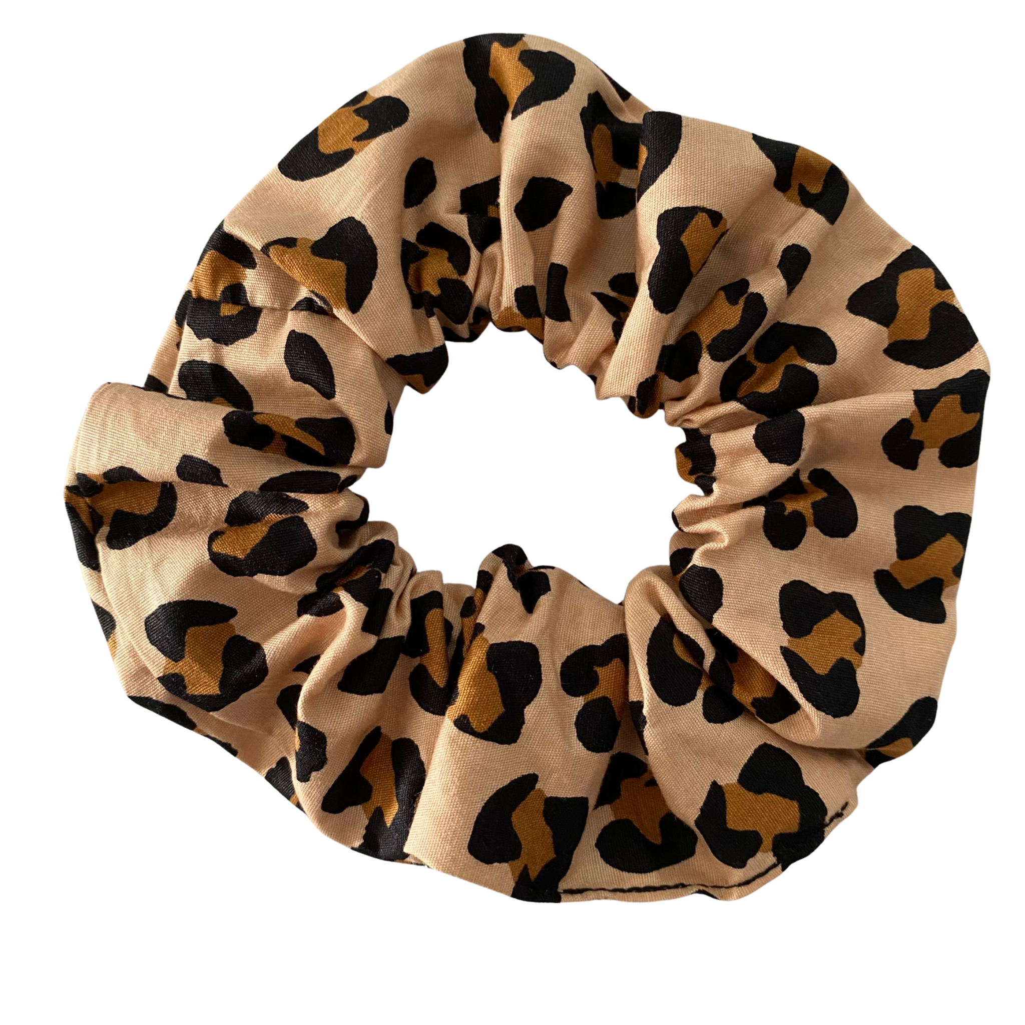 Leopard print scrunchie on a light brown background.