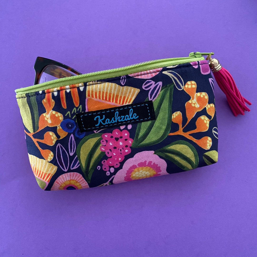 Protect your glasses with our padded, fully lined glasses case featuring colourful full bloom flowers on navy fabric by Kirsten Katz. Perfect pouch for eyewear and small essentials.