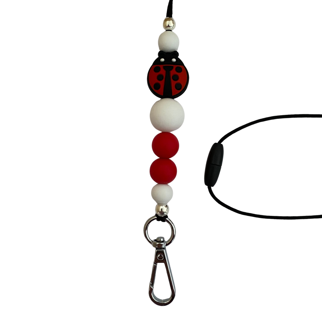 A 60cm lanyard fitted with a safety break away clasp featuring a ladybug bead and other coloured round silicone beads.