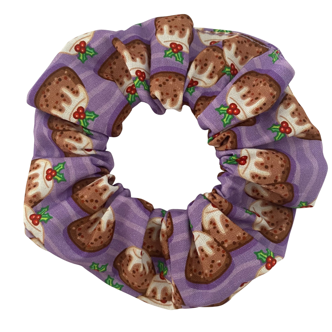 Scrunchie with plum puddings on a purple background.
