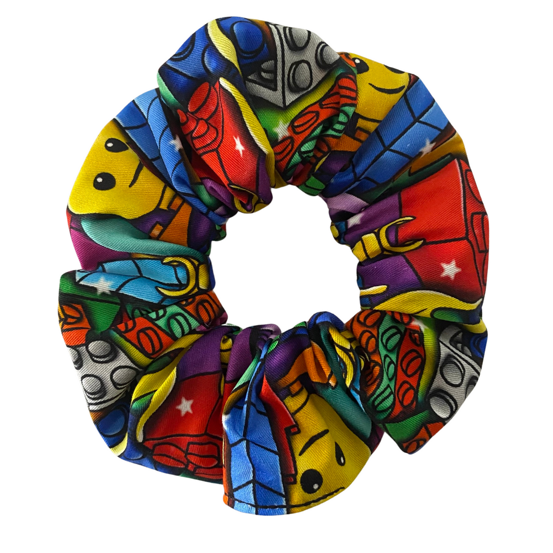A colourful scrunchie with images of LEGO building bricks. A fun pick for LEGO fans!