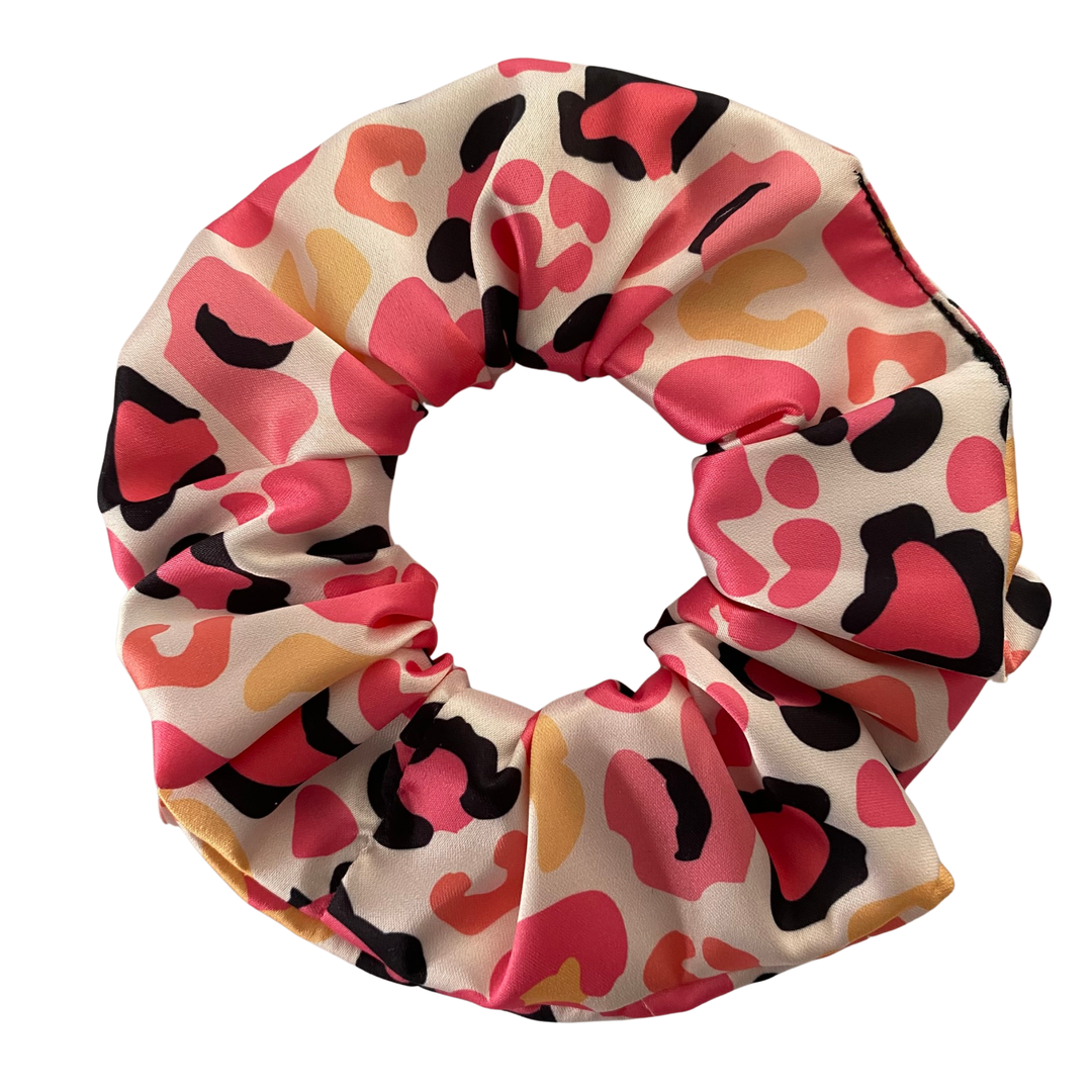 Colourful leopard pattern scrunchie on a white background.